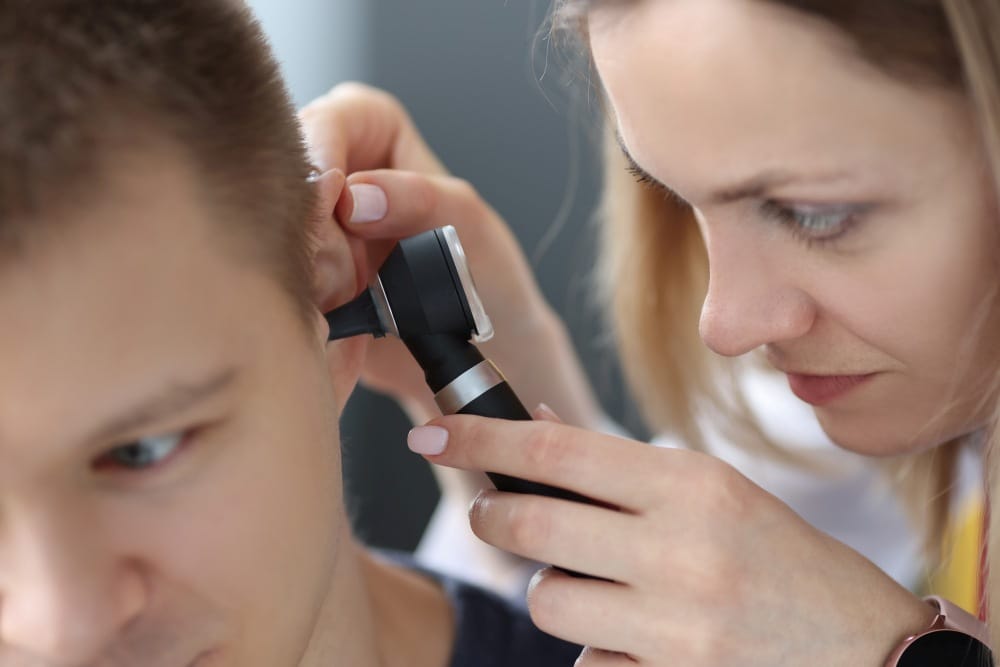 specialist performing microsuction earwax removal Newmarket at the clinic